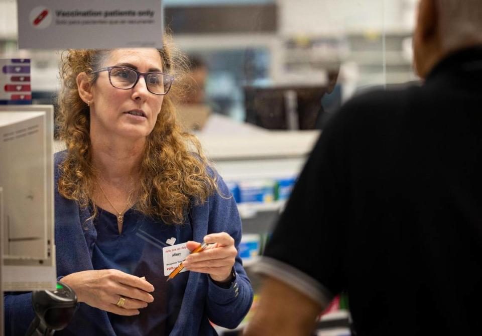 Altinay helps a Spanish speaking customer during a visit to CVS Pharmacy on Monday, Oct. 16, 2023, located on SW 40th Street in Miami. CDC Director Mandy Cohen talked of the importance of reaching the hispanic community with the new RSV COVID-19 vaccine.