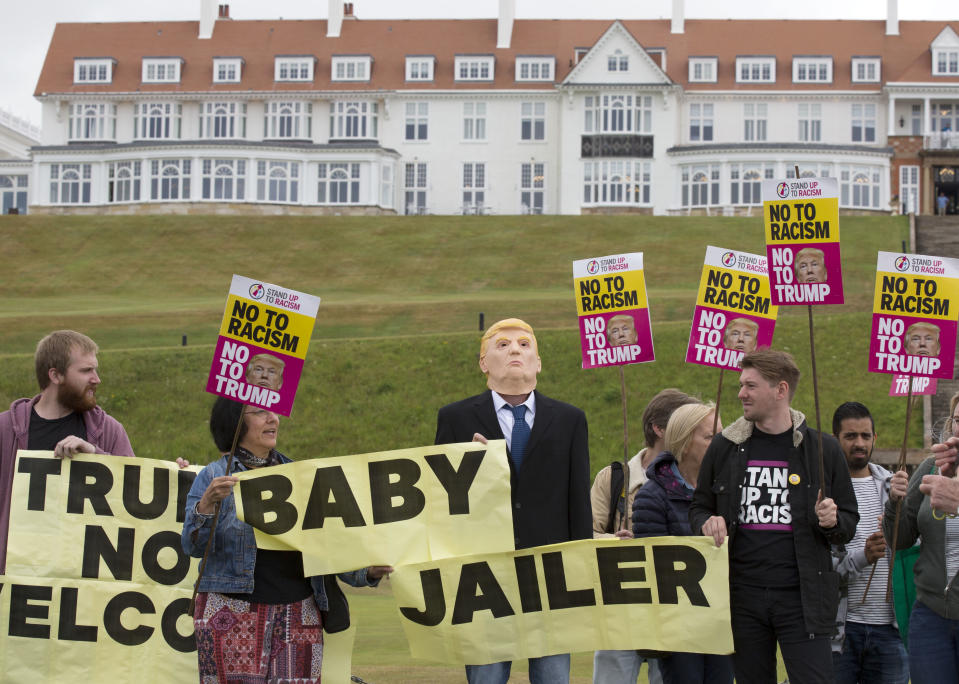 <p>Activists from Stand Up to Racism Scotland (SUTR) stage a protest at the Trump Turnberry resort ahead of the president’s arrival in the UK, in South Ayrshire, Scotland, Wednesday, July 11, 2018. (Photo: David Cheskin/PA via AP) </p>