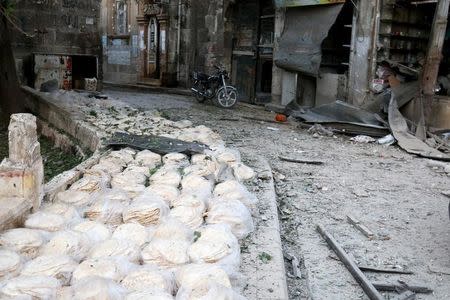 Stacks of bread are seen at a damaged site after an airstrike in the rebel-held Bab al-Maqam neighbourhood of Aleppo, Syria, September 28, 2016. REUTERS/Abdalrhman Ismail