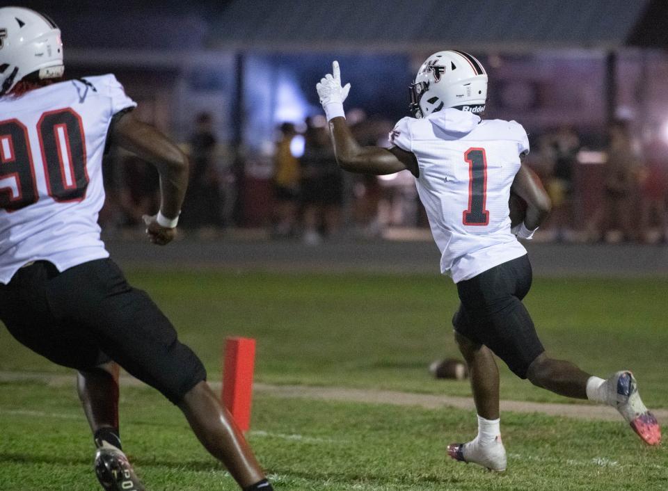 Trevon Knott (1) celebrates his pick 6 to take a 13-7 Jaguars lead during the West Florida vs Navarre preseason football game at Navarre High School on Friday, Aug. 18, 2023.