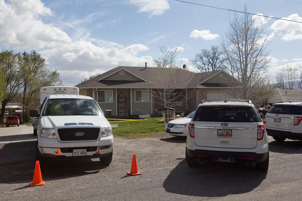 Authorities investigate a crime scene at a house in Pleasant Grove Utah, Sunday, April 13, 2014. (AP Photo/Daily Herald, Mark Johnston)