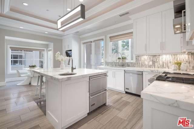 <p>The home now boats a chef’s kitchen with natural stone and wood floors, following the remodel. <br> (Realtor.com) </p>