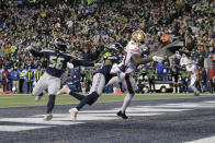 San Francisco 49ers wide receiver Trent Sherfield, right, reaches for an incomplete pass as Seattle Seahawks outside linebacker Jordyn Brooks (56) and cornerback Sidney Jones, center, defend during the second half of an NFL football game, Sunday, Dec. 5, 2021, in Seattle. The Seahawks won 30-23. (AP Photo/John Froschauer)