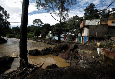 A street collapsed by Tiribi river is seen after Storm Nate in the outskirts of San Jose, Costa Rica October 6, 2017. REUTERS/Juan Carlos Ulate