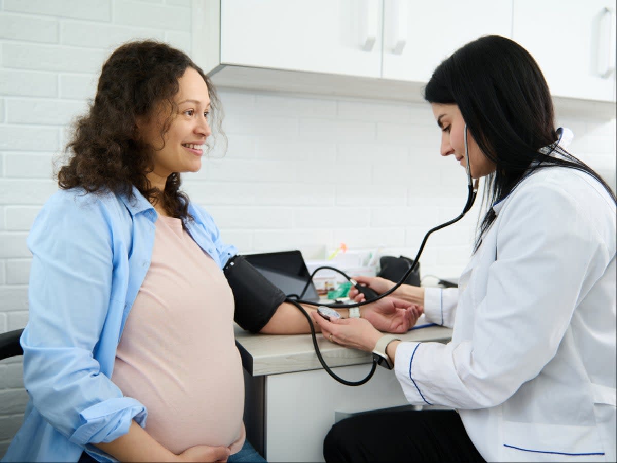 Obstetrician checks pregnant woman’s blood pressure  (iStock)