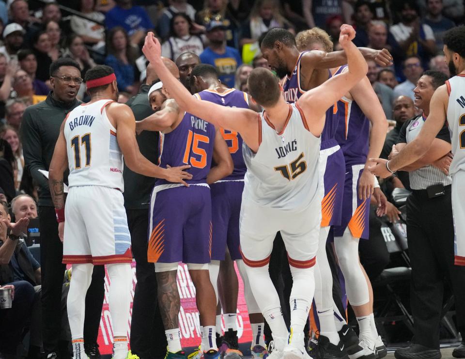 Phoenix Suns forward Kevin Durant (35) pushes Denver Nuggets center Nikola Jokic (15) away from his team’s huddle during the third quarter of the Western Conference semifinals at Ball Arena in Denver on May 9, 2023.