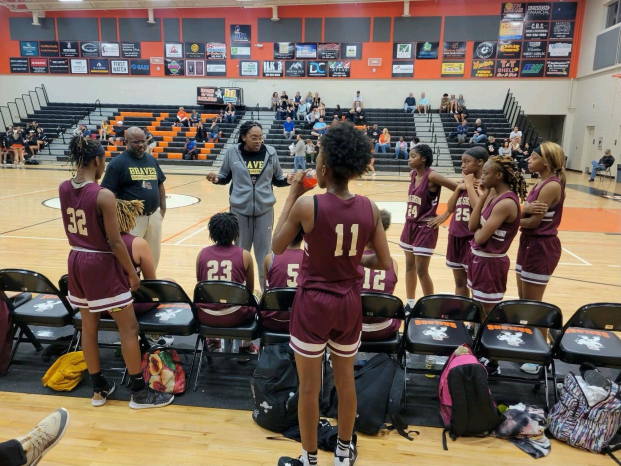 Lake Gibson head girls basketball coach Antonia Bennett, grey shirt, and assistant coach Marquis Roberts coach up the team in a contest vs. Sarasota High School on Nov. 17, 2022. Lake Gibson won this game 72-68.