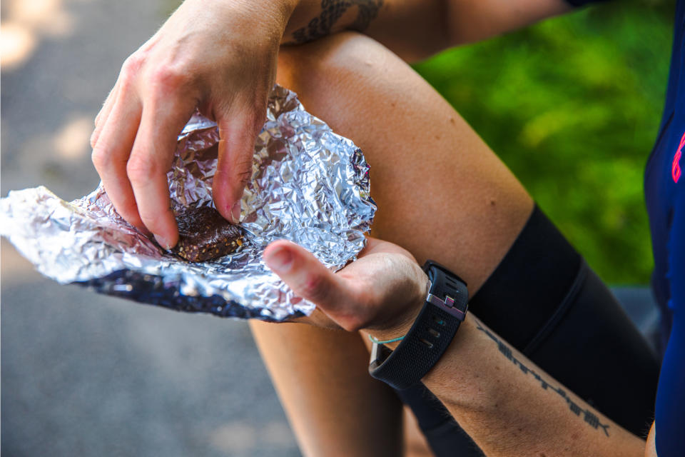 Female cyclist eating a handmade energy bar