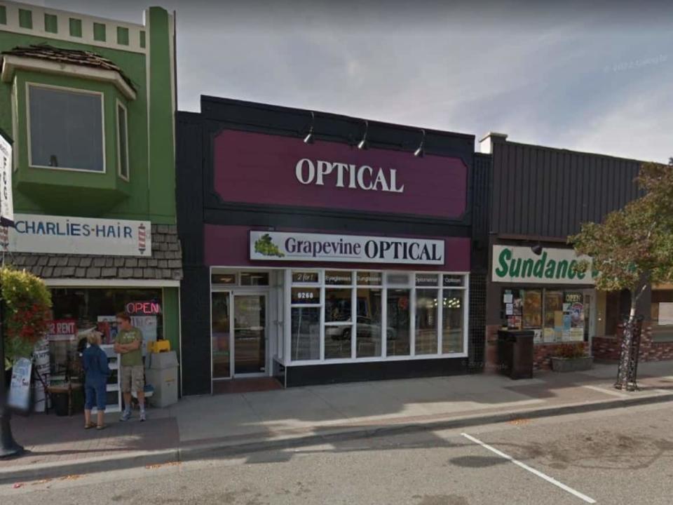 Grapevine Optical is pictured on Main Street in Oliver, B.C. The store owner has been ordered to pay his former manager over $70,000 for wages lost, and compensation for injury to her dignity as a result of discrimination, according to a tribunal decision published Wednesday. (Google Street View - image credit)