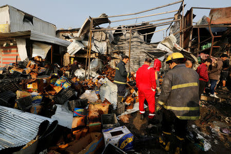 Firemen gather at the site of a car bomb attack at a vegetable market in eastern Baghdad, Iraq , January 8, 2017. REUTERS/Wissm al-Okili