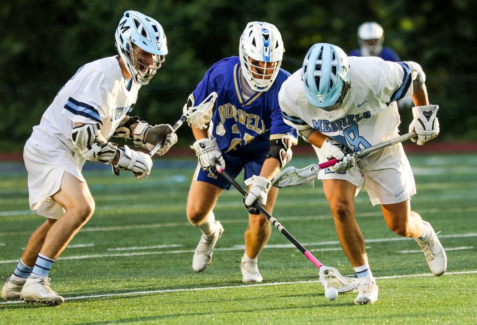 Norwell's Ronan Schipani battles for a ground ball during the Division 3 state title game against Medfield on the campus of Worcester State University on Wednesday, June 22, 2022.