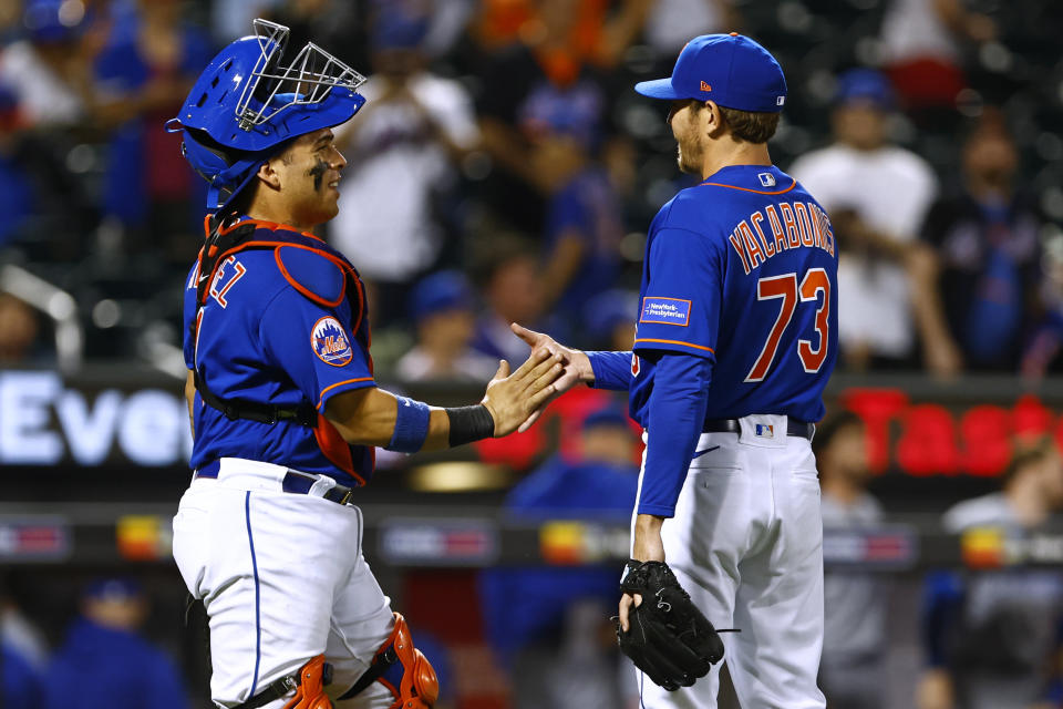 New York Mets catcher Francisco Alvarez (4) shakes hands with relief pitcher Jimmy Yacabonis (73) during the eighth inning of a baseball game, Monday, Aug. 7, 2023, in New York. The Mets defeated the Cubs 11-2. (AP Photo/Rich Schultz)