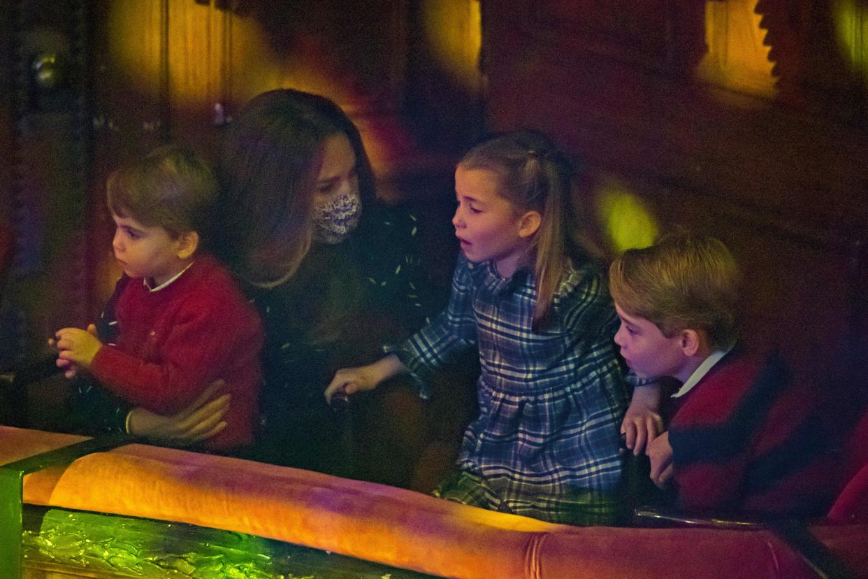 Britain's Catherine, Duchess of Cambridge (2nd L) holds Britain's Prince Louis of Cambridge (L) as she speaks with Britain's Princess Charlotte of Cambridge (2nd R) and Britain's Prince George of Cambridge (R) at a special pantomime performance of The National Lotterys Pantoland  at London's Palladium Theatre in London on December 11, 2020, to thank key workers and their families for their efforts throughout the pandemic. (Photo by Aaron Chown / POOL / AFP) (Photo by AARON CHOWN/POOL/AFP via Getty Images)