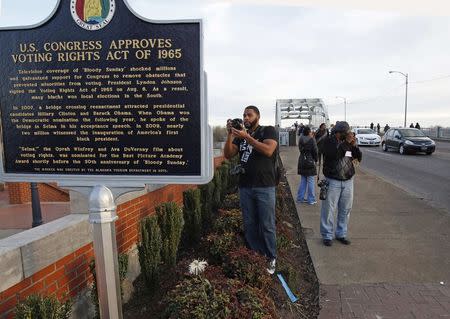 People take pictures along the Edmund Pettus Bridge commemorating the 50th anniversary march in Selma, Alabama March 6, 2015. REUTERS/Tami Chappell