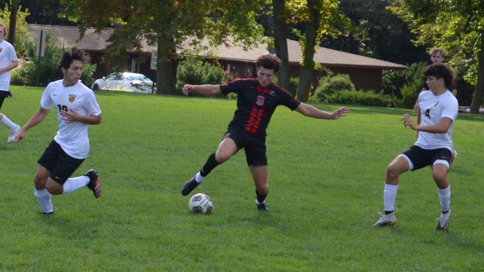 Aidan Quinn Wright (9) of Cinnaminson brings the ball under control between Moorestown's Robert Intenzo (4) and Liam Ryan (10) during Wednesday's game.