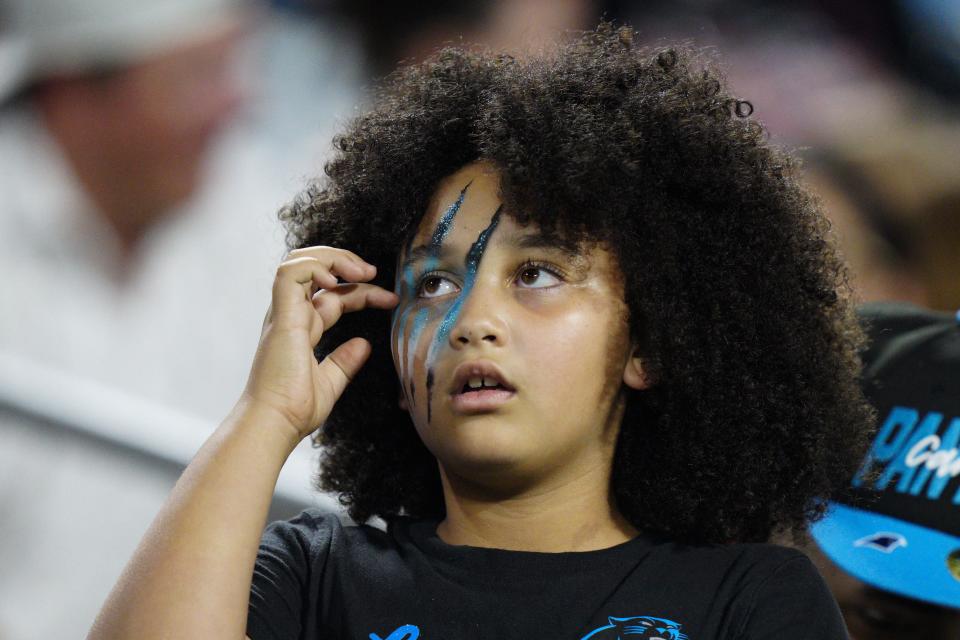Carolina Panthers fans watches during the first half of an NFL preseason football game against the Buffalo Bills on Friday, Aug. 26, 2022, in Charlotte, N.C. (AP Photo/Jacob Kupferman)