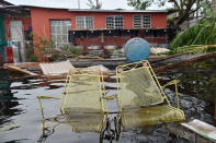 <p>Chairs are seen in front of a flooded house in Juana Matos, Catano, Puerto Rico, on Sept. 21, 2017. (Photo: Hector Retamal/AFP/Getty Images) </p>