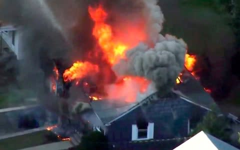 Flames consume a home in Lawrence, Massachusetts, a suburb of Boston - Credit: WCVB