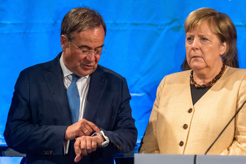 Angela Merkel stands next to Armin Laschet who is vying to replace her as chancellor.