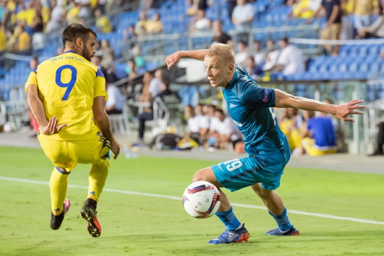 Zenit St. Petersburg's Igor Smolnikov (R) attempts to move past Maccabi's Eden Ben Basat during their UEFA Europa League Group D match, at Netanya Stadium in Netanya, Israel, on September 15, 2016