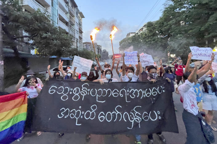A small group of protesters hold a banner which reads in Burmese 'Do not support the bloody education, revolt until the end' while calling for a boycott of the education system under the military government that ousted Myanmar leader Aung San Suu Kyi, during a flash mob rally in Tarmwe township in Yangon, Myanmar, Wednesday, Nov. 10, 2021. (AP Photo)