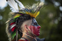 Zachary Orchard, of the Shoal Lake 40 First Nation on the Manitoba and Ontario border, listens during a ceremony and vigil for the 215 children whose remains were found buried at the former Kamloops Indian Residential School, in Vancouver, British Columbia, on National Indigenous Peoples Day, Monday, June 21, 2021. (Darryl Dyck/The Canadian Press via AP)