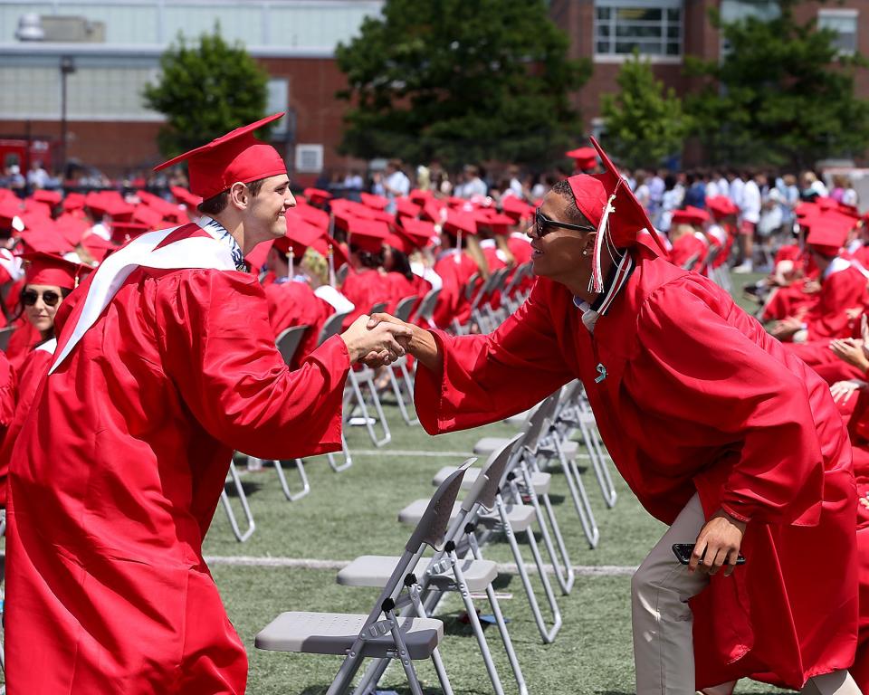 Senior Jonathan St. Ange congratulates Nate Melendes during Hingham High's graduation at Hingham High School on Saturday, June 4, 2022.