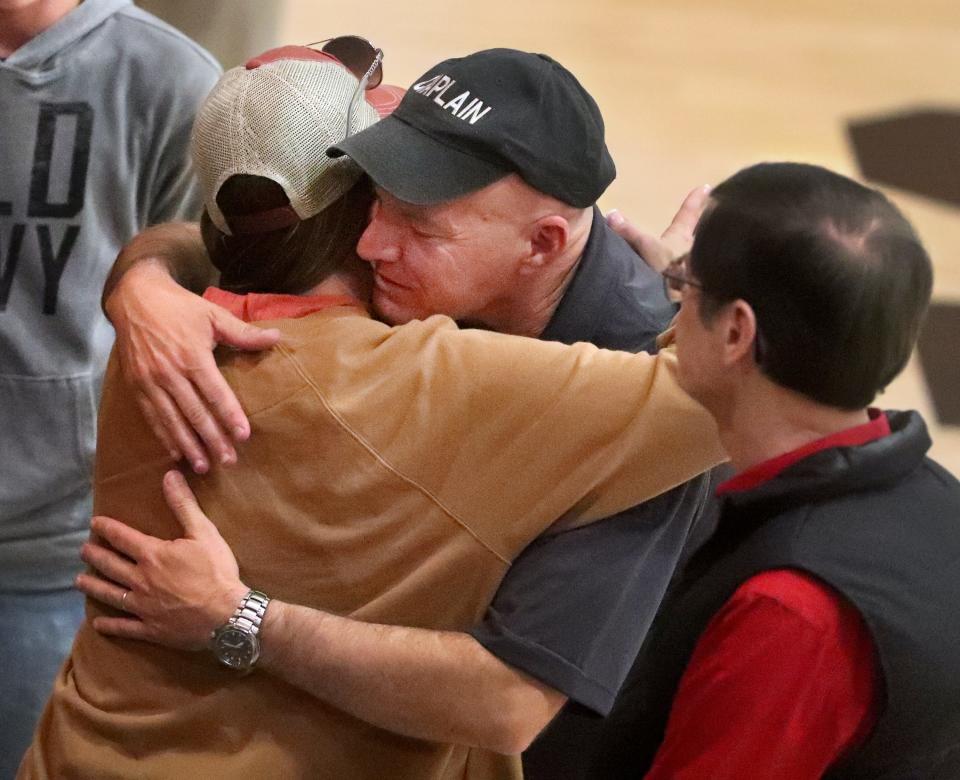 Maj. Tim Morgan, a law enforcement chaplain, who also serves on active duty, gives a hug to a man that he prayed with at the end of the Little River Baptist Association program where veteran Jeff Struecker, whose experiences were portrayed in the movie Black Hawk Down, spoke at the Trigg County High School gymnasium, in Cadiz, Kentucky, on Thursday, March 30, 2023, about his faith and military career as a Chaplin and soldier. The event was held near the crash site of two Black Hawk helicopters from Fort Campbell that crashed the night before.