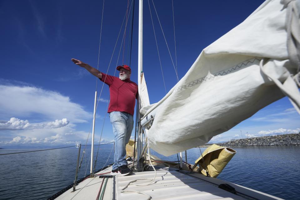 Randy Atkin sails on the Great Salt Lake on June 14, 2023, near Magna, Utah. Sailors back out on the water are rejoicing after a snowy winter provided temporary reprieve. (AP Photo/Rick Bowmer)