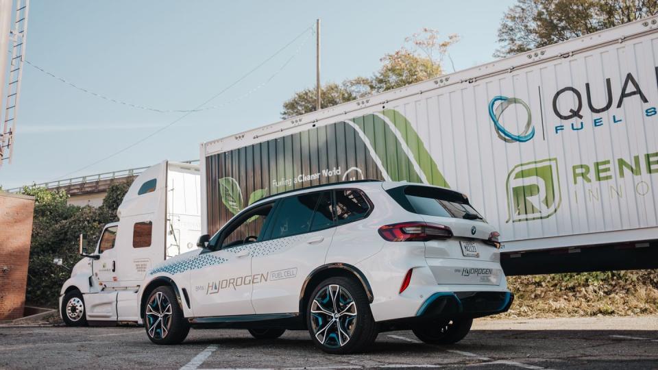 a white car parked in front of a trailer