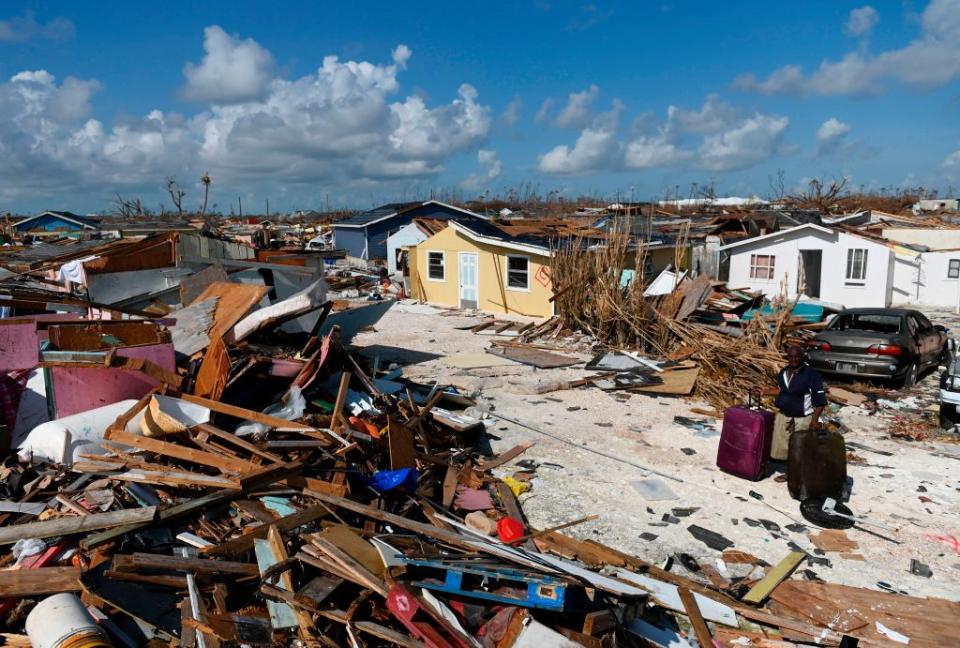 A man collects his belongings before going to the port in Marsh Harbour, Bahamas to evacuate on September 10, 2019. | Andrew Caballero-Reynolds—AFP/Getty Images