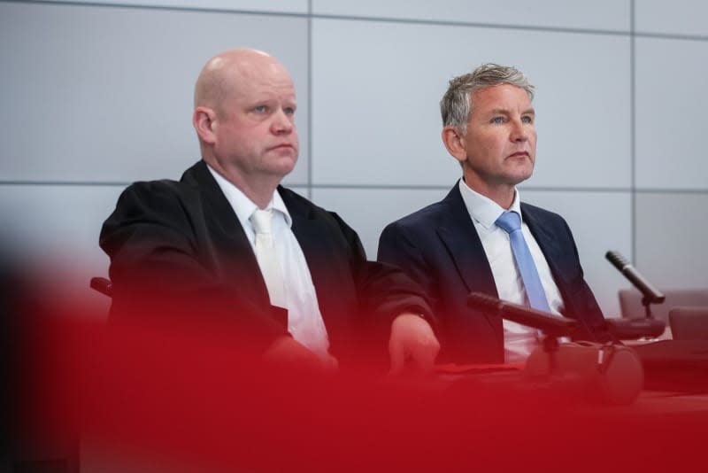 Bjoern Hoecke (R), chairman of the Thuringian AfD party, waits with his lawyer Ulrich Vosgerau for the start of his trial at the Halle/Saale district court. He is accused of using symbols of unconstitutional and terrorist organizations. Ronny Hartmann/AFP Pool/dpa