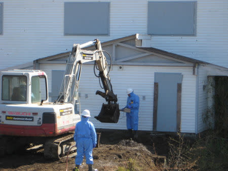 Workers hired by the Navy prepare to dig for environmental contamination, including radioactive debris, buried in front of homes on Treasure Island, near San Francisco, California, U.S., in this June 2009 handout photo Handout via REUTERS