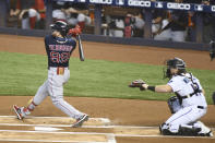 Boston Red Sox centerfielder Alex Verdugo hits a single to right field during the first inning of a baseball game against the Miami Marlins, Thursday, Sept. 17, 2020, in Miami. (AP Photo/Gaston De Cardenas)