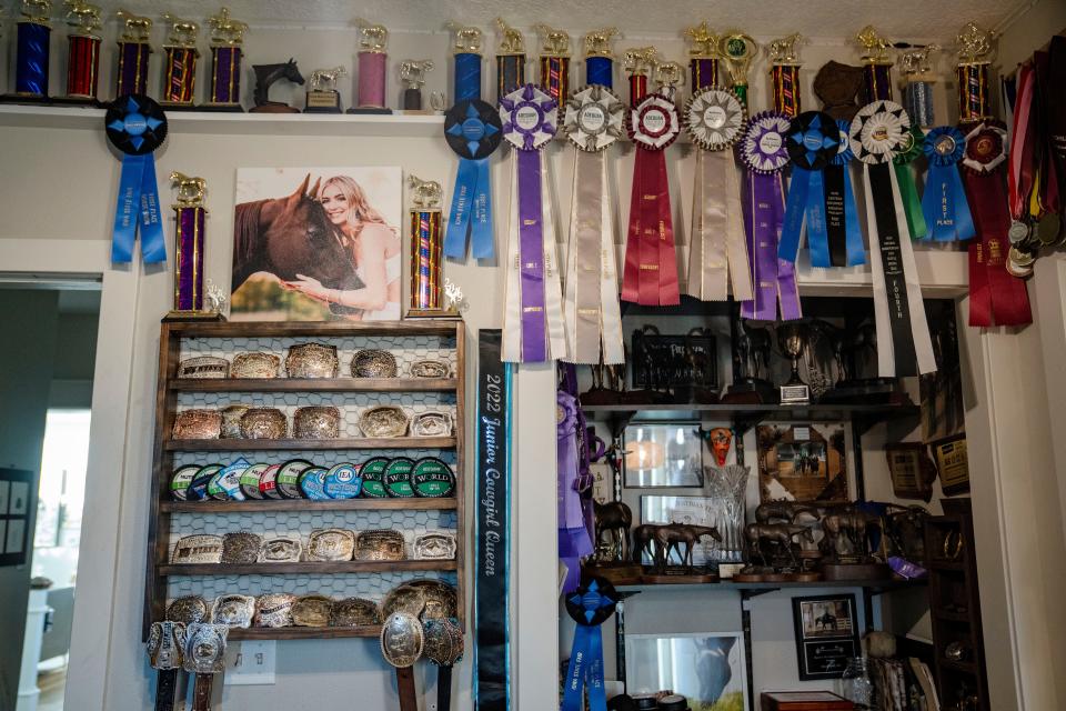 Trophies and ribbons line the walls of Elivia room.