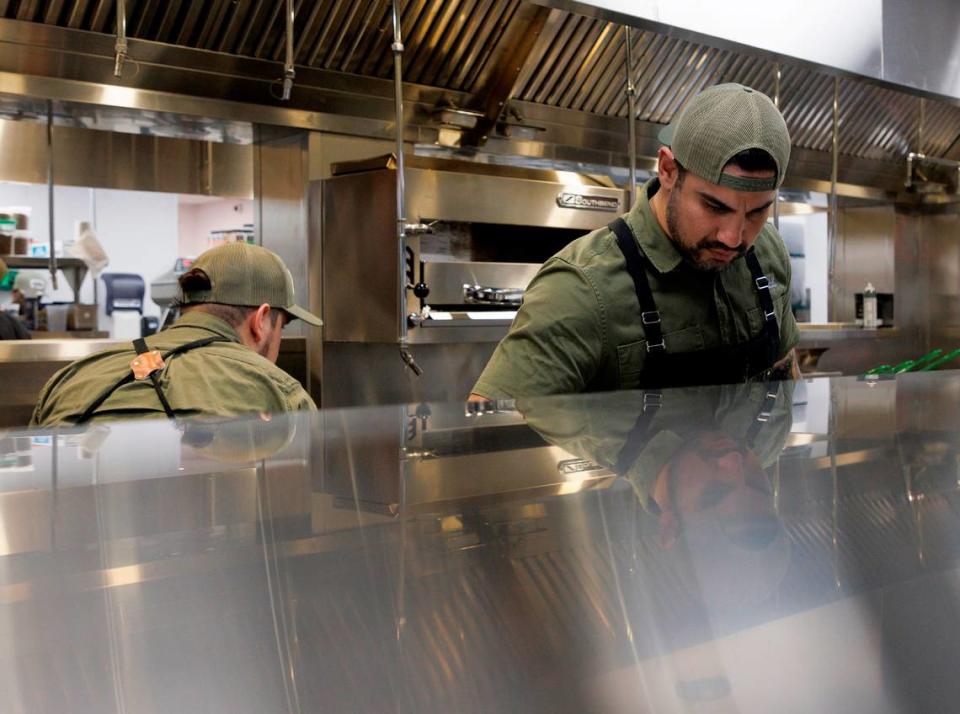 Chef Manny Barella, right, works in the kitchen at Jaguar Bolera in Raleigh, N.C. on Tuesday, May 14, 2024.