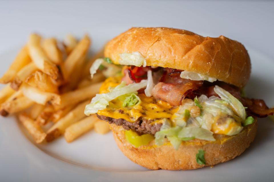 The Single Tasty burger with lettuce, banana peppers, bacon, cheese and ranch, with a side of fries, from Relish.
