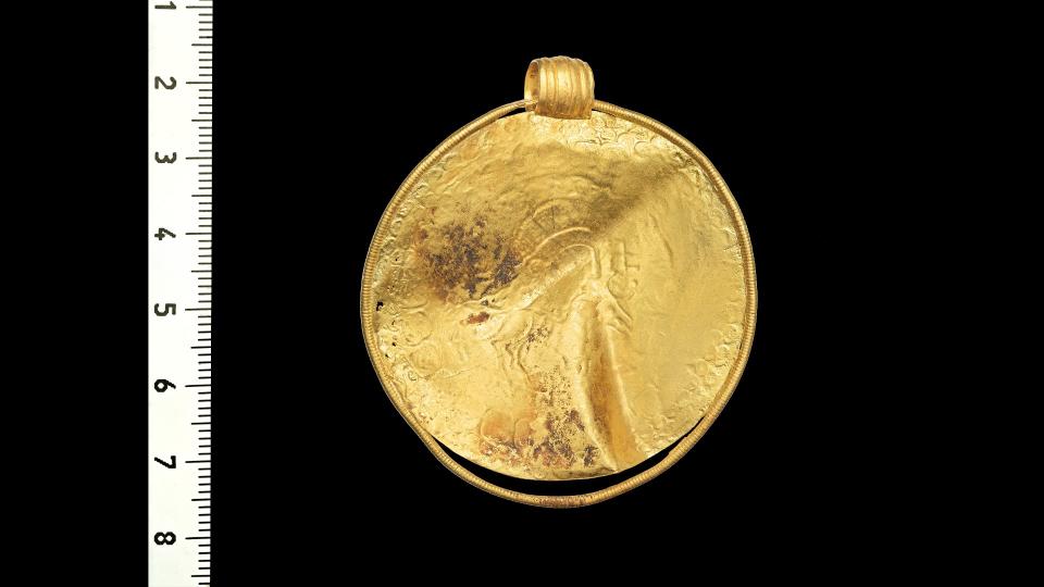 The other side of the bracteate is stamped with a badly-worn design, which includes a horse but has no inscription.