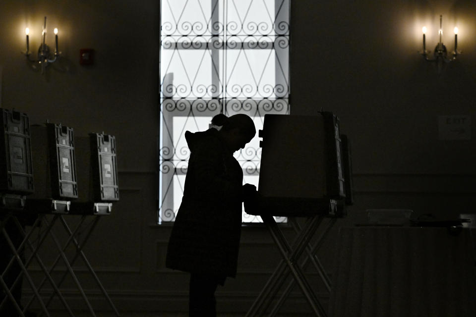 FILE - A woman votes at the Crystal Ballroom in New Britain, Conn., Nov. 8, 2022. Lawmakers in several Democratic-controlled states are pushing sweeping voting protections this year, reacting to what they view as a broader assault on voting rights by the Supreme Court and Republican-led states. (AP Photo/Jessica Hill, File)