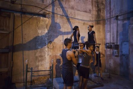 Children practise during a training session at a circus school in Havana, October 7, 2014. REUTERS/Alexandre Meneghini