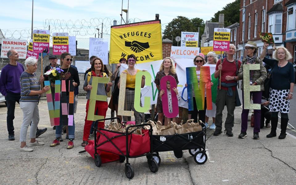 Protesters deliver 'welcome packs' at the front gate to the Bibby Stockholm