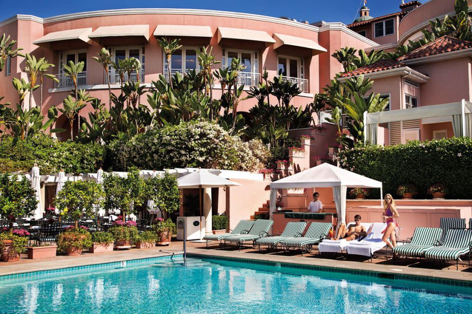 The Beverly Hills Hotel pool area which provides underwater music and complimentary sunglasses cleaning.