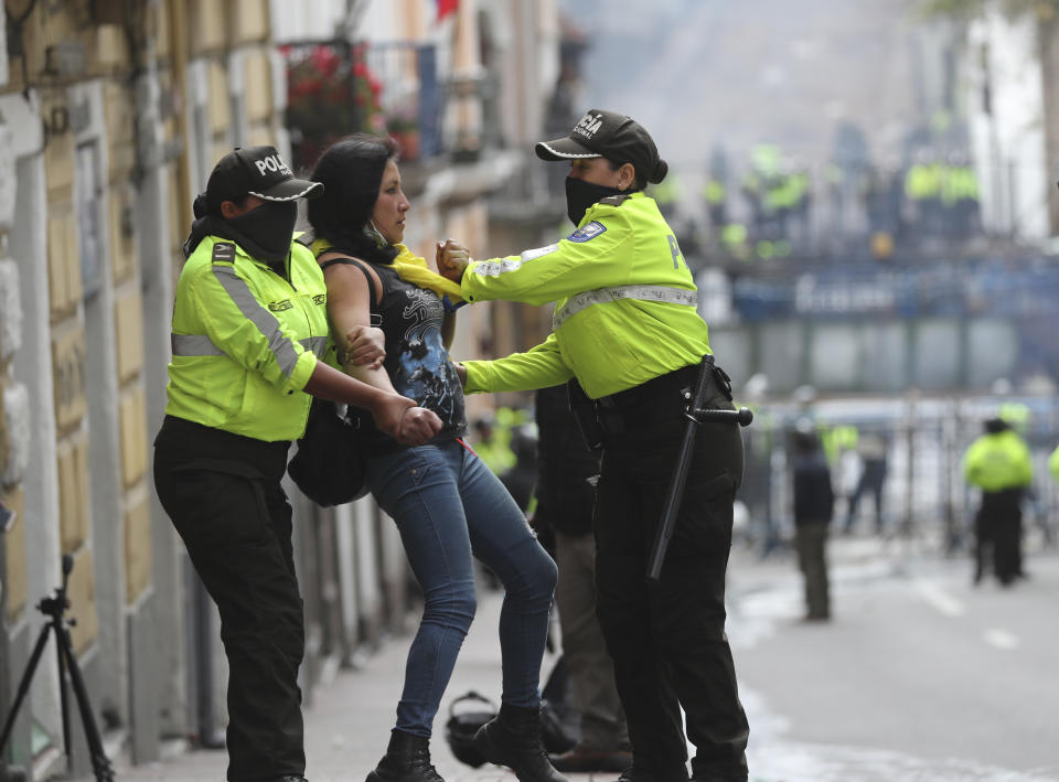 An anti-government protester is detained by police during a nationwide strike against President Lenin Moreno and his economic policies, in Quito, Ecuador, Wednesday, Oct. 9, 2019. Protests, which began when Moreno's decision to cut subsidies led to a sharp increase in fuel prices, have persisted for days. (AP Photo/Dolores Ochoa)