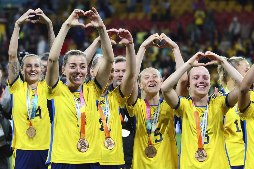Sweden gesture to supporters as they celebrate with their bronze medals after defeating Australia in the Women's World Cup third place playoff soccer match in Brisbane, Australia, Saturday, Aug. 19, 2023. (AP Photo/Tertius Pickard)