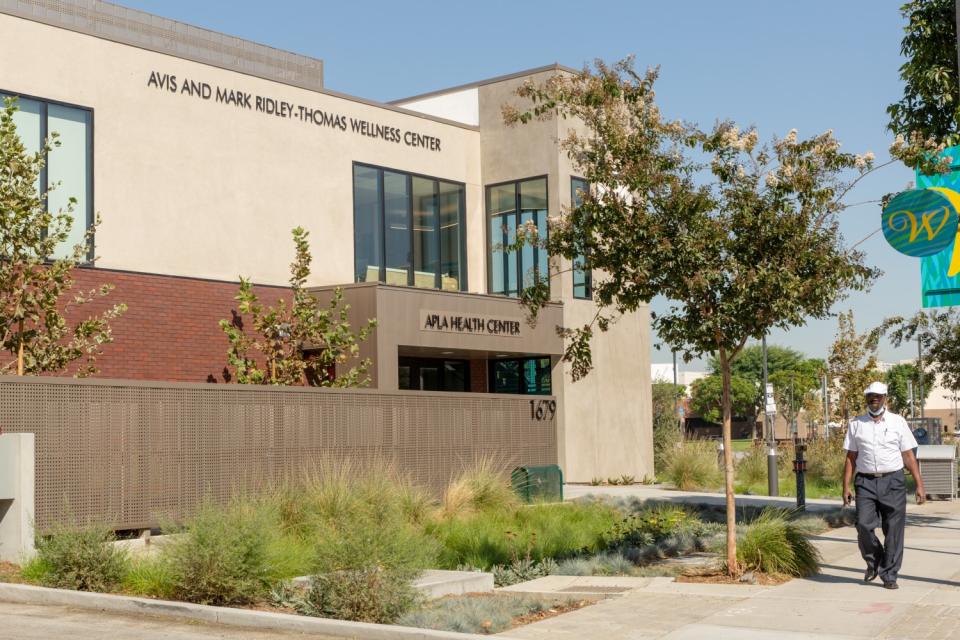 A man walks by the Avis and Mark Ridley-Thomas Wellness Center on the Charles R. Drew University in Los Angeles.