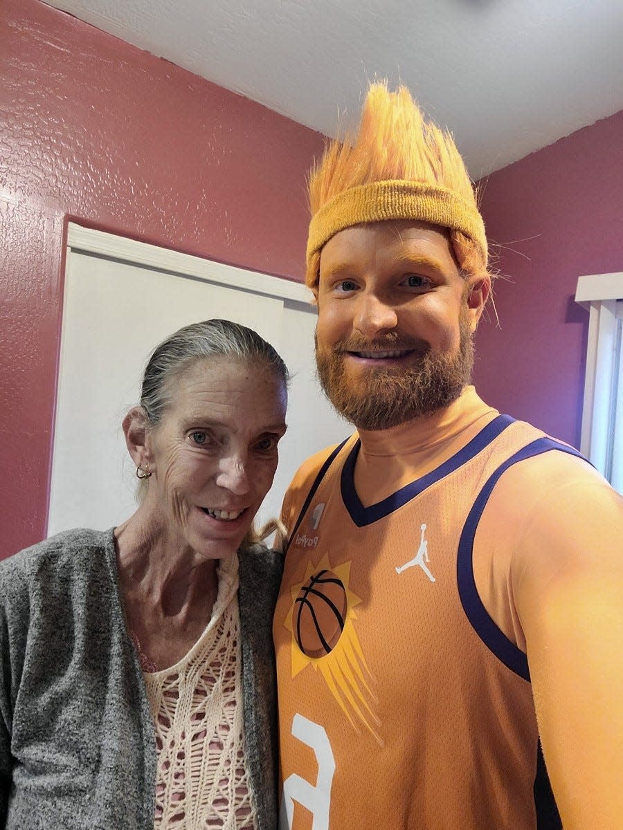 Patrick Battillo (aka Phoenix Suns super fan Mr. ORNG) stands with his mother Carol Mead before a game.