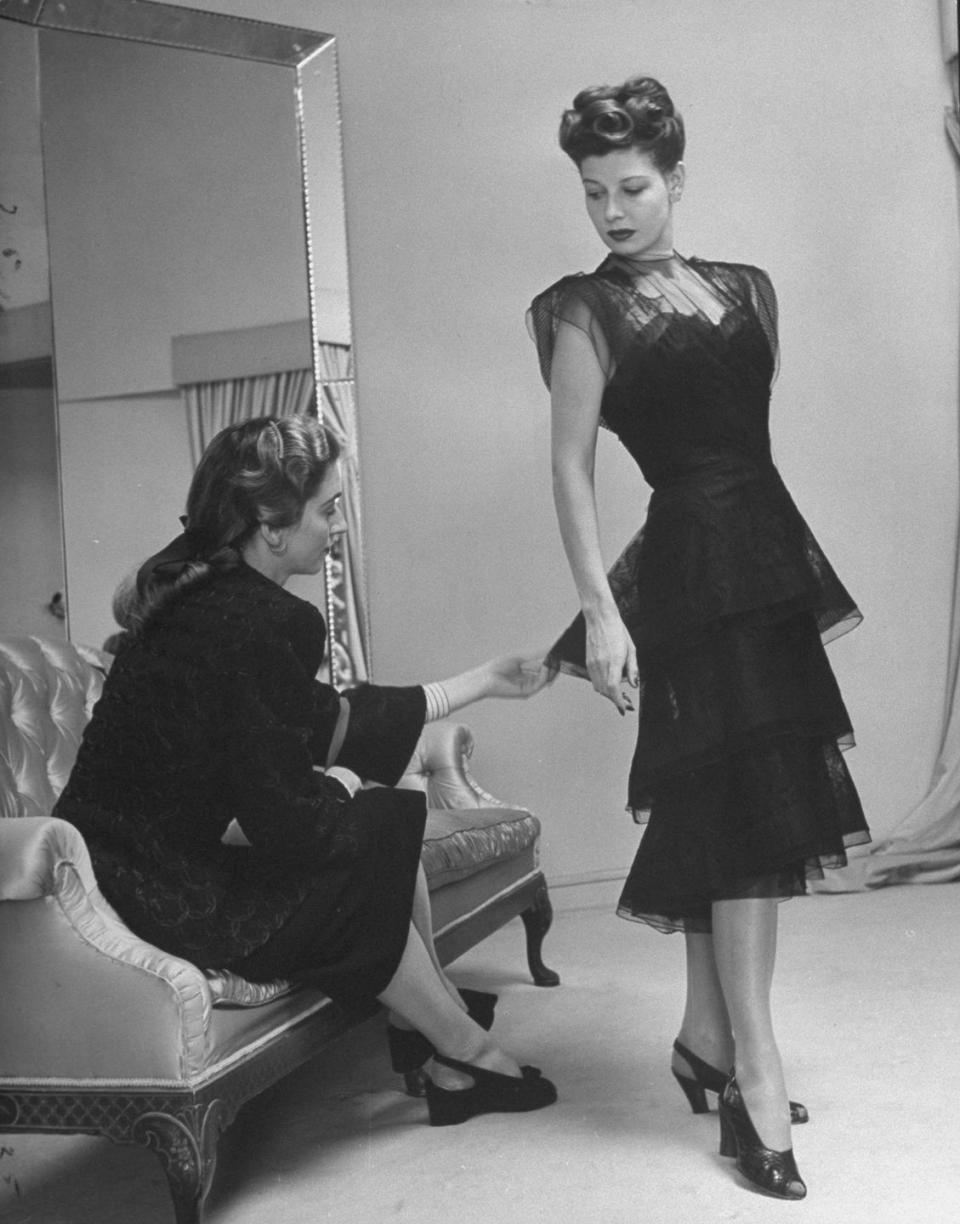 <p>Miss America in 1939, Pat Donnelly, is seen here modeling a tulle black evening gown with a tiered skirt. Her perfectly curled up-do only adds to the polished look. </p>