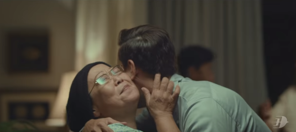 A man in Malaysia Airlines’ ‘Sama-Sama Balik Kampung’ video, embraces his mother after he surprised her by coming home for Hari Raya. — Screengrab via Youtube/ Malaysia Airlines