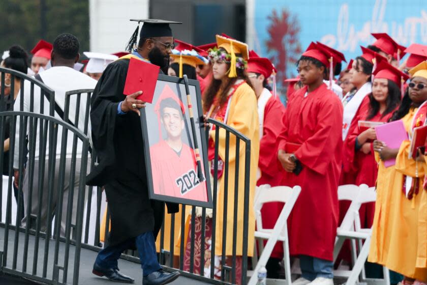 Morningside High staff member Eddie Conner holds a picture of David Ceja