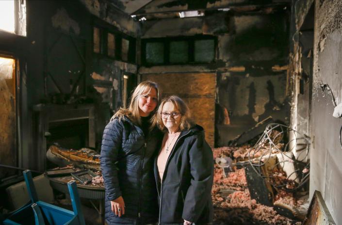 JoEllen Myers, left, is joined by her granddaughter, Anna Myers, in the living room of JoEllen&#xd5;s townhome on Thursday, Dec. 23, 2021. JoEllen&#xd5;s home was gutted by fire after a car crashed into her living room early on Monday, Dec. 20, 2021. 